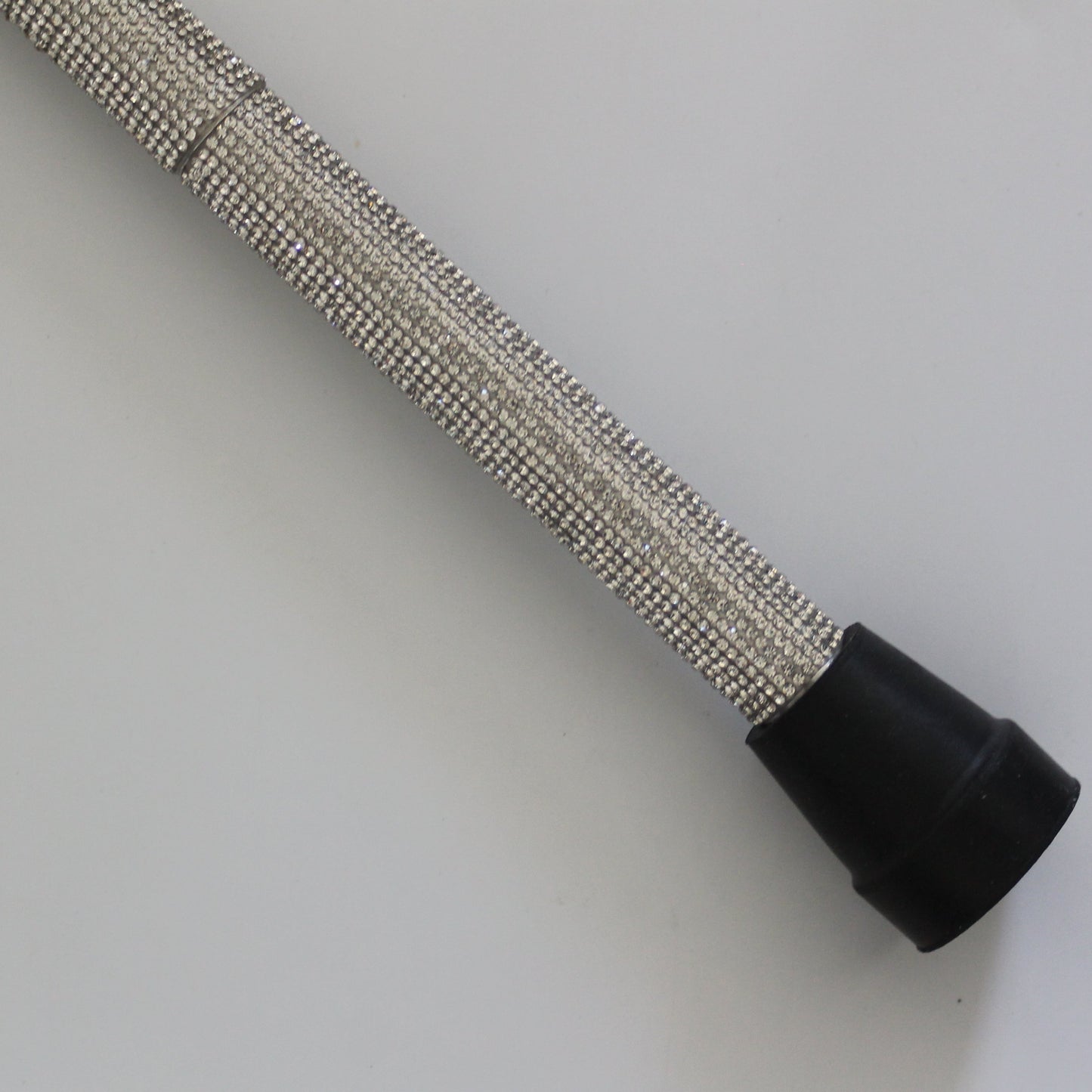 Metallic hose with black end on a white background