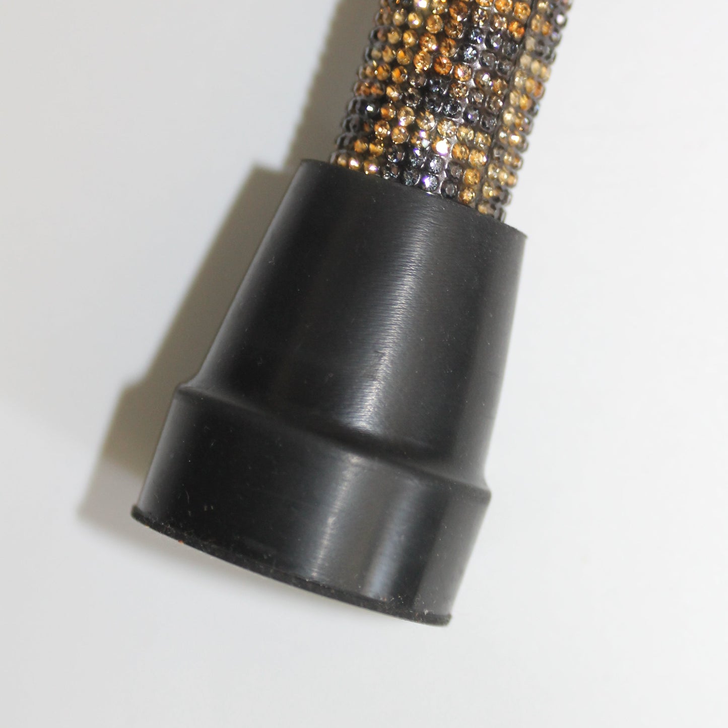 Close-up of a black and gold textured object on a white background
