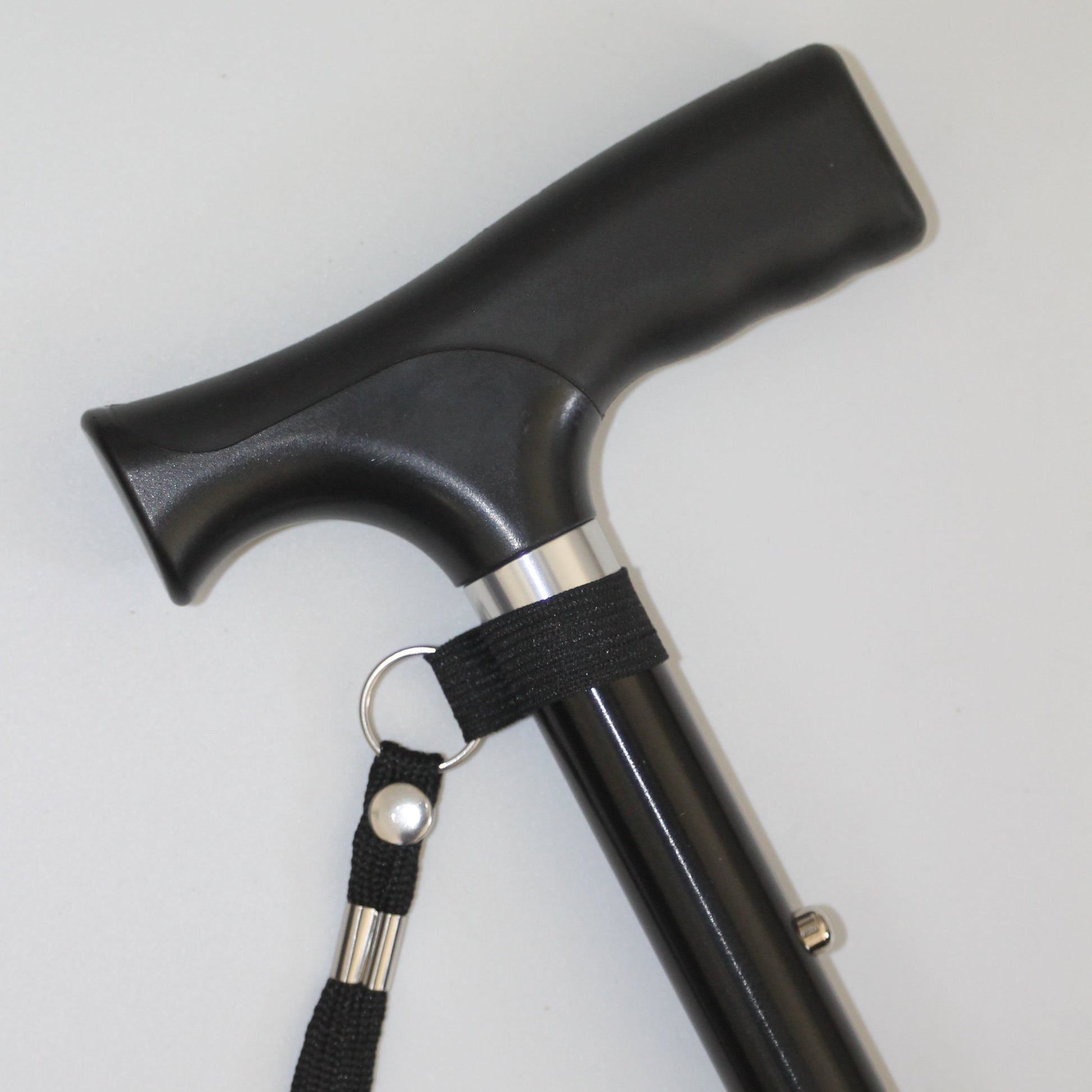 Black walking cane with a strap 