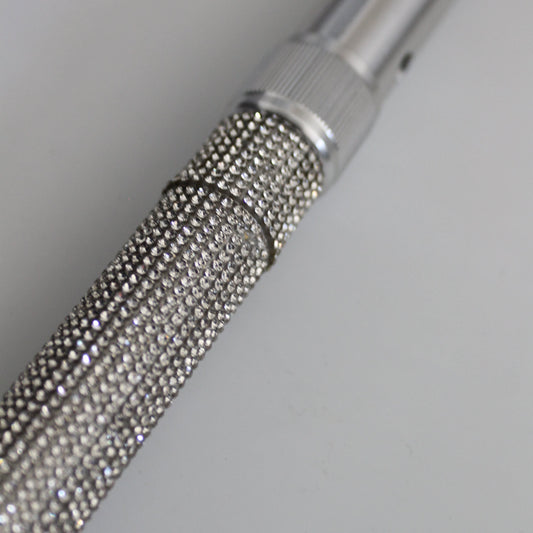 Metallic textured rod on a light gray background