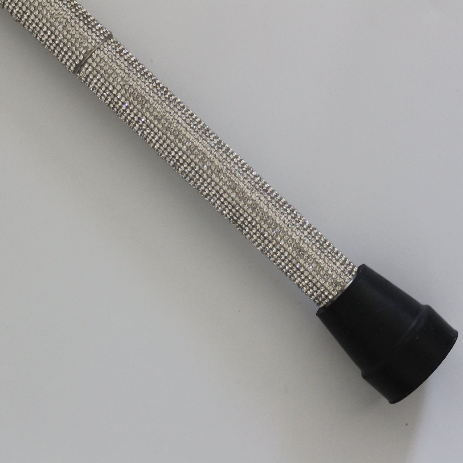 Metallic hose with black end on a white background