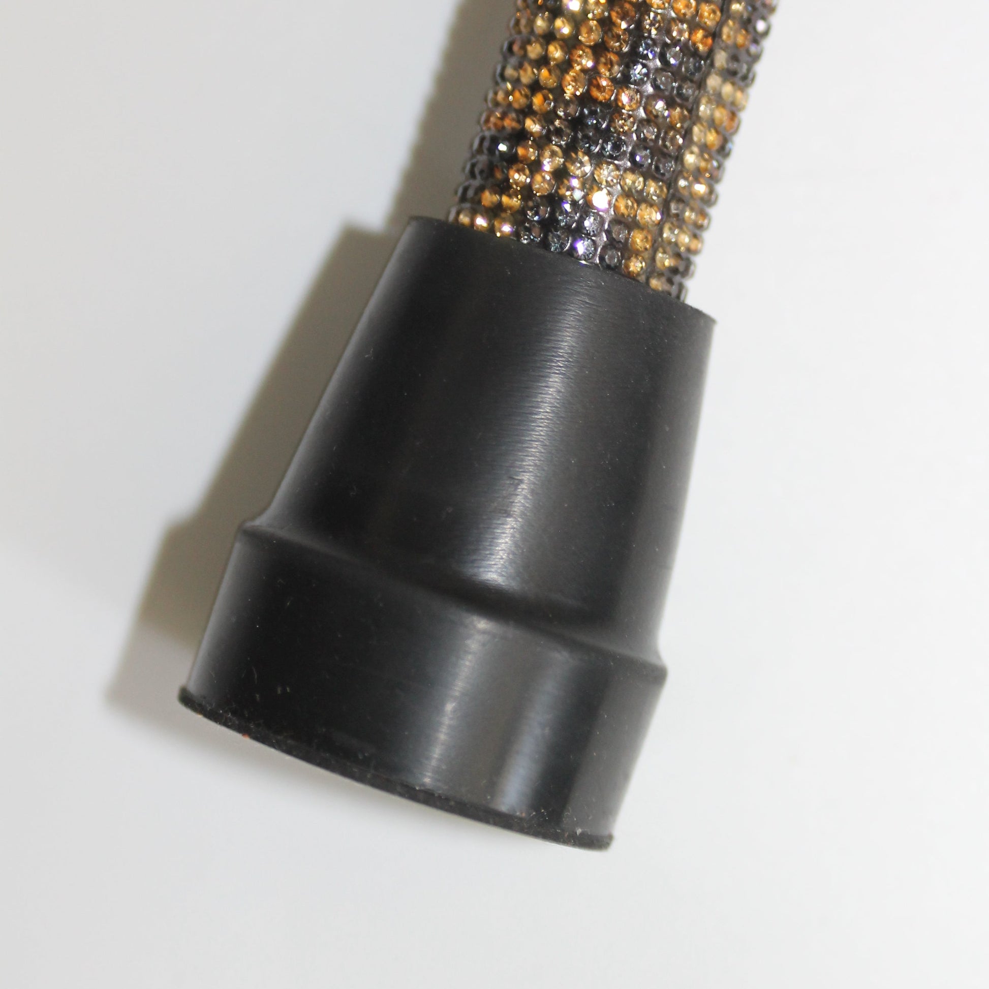 Close-up of a black and gold textured object on a white background